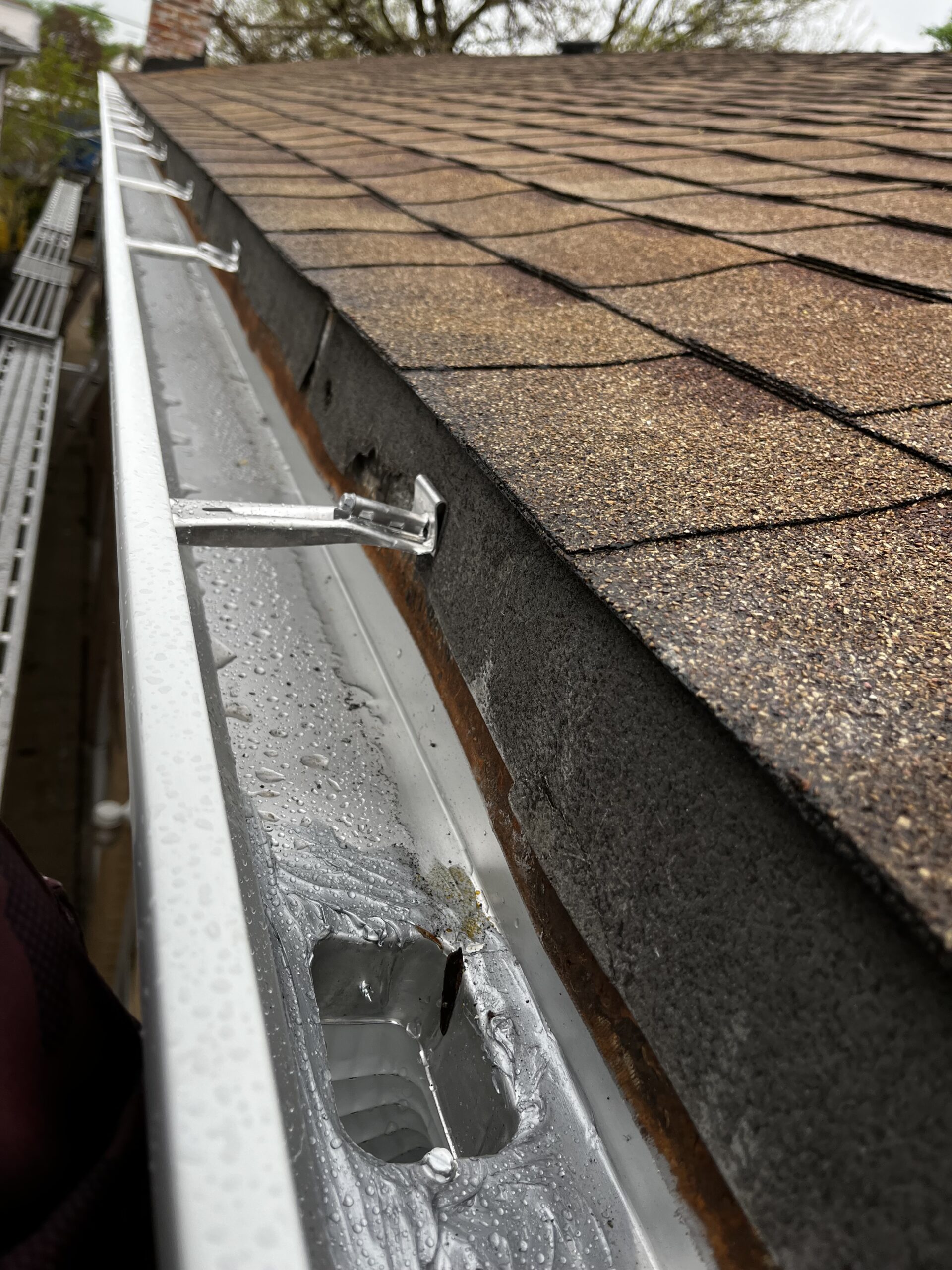 gutter repair Chicago technician repairing leaking gutter